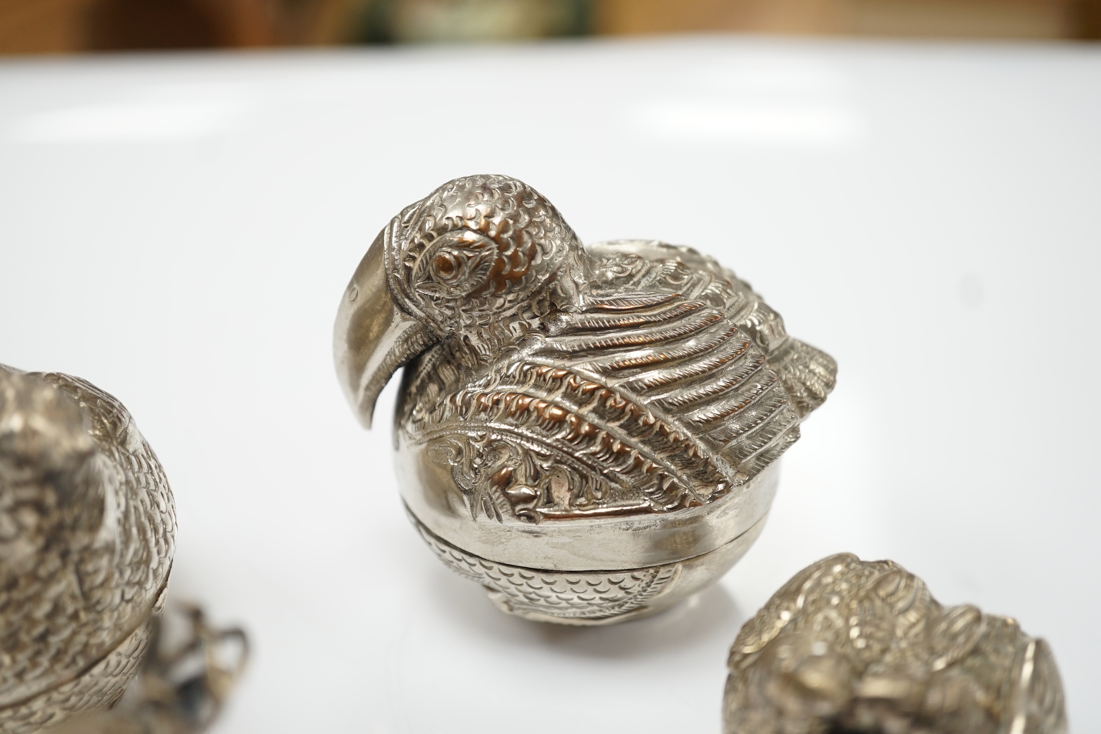 Four South East Asian white metal small ‘animal’ boxes. Largest 6cm